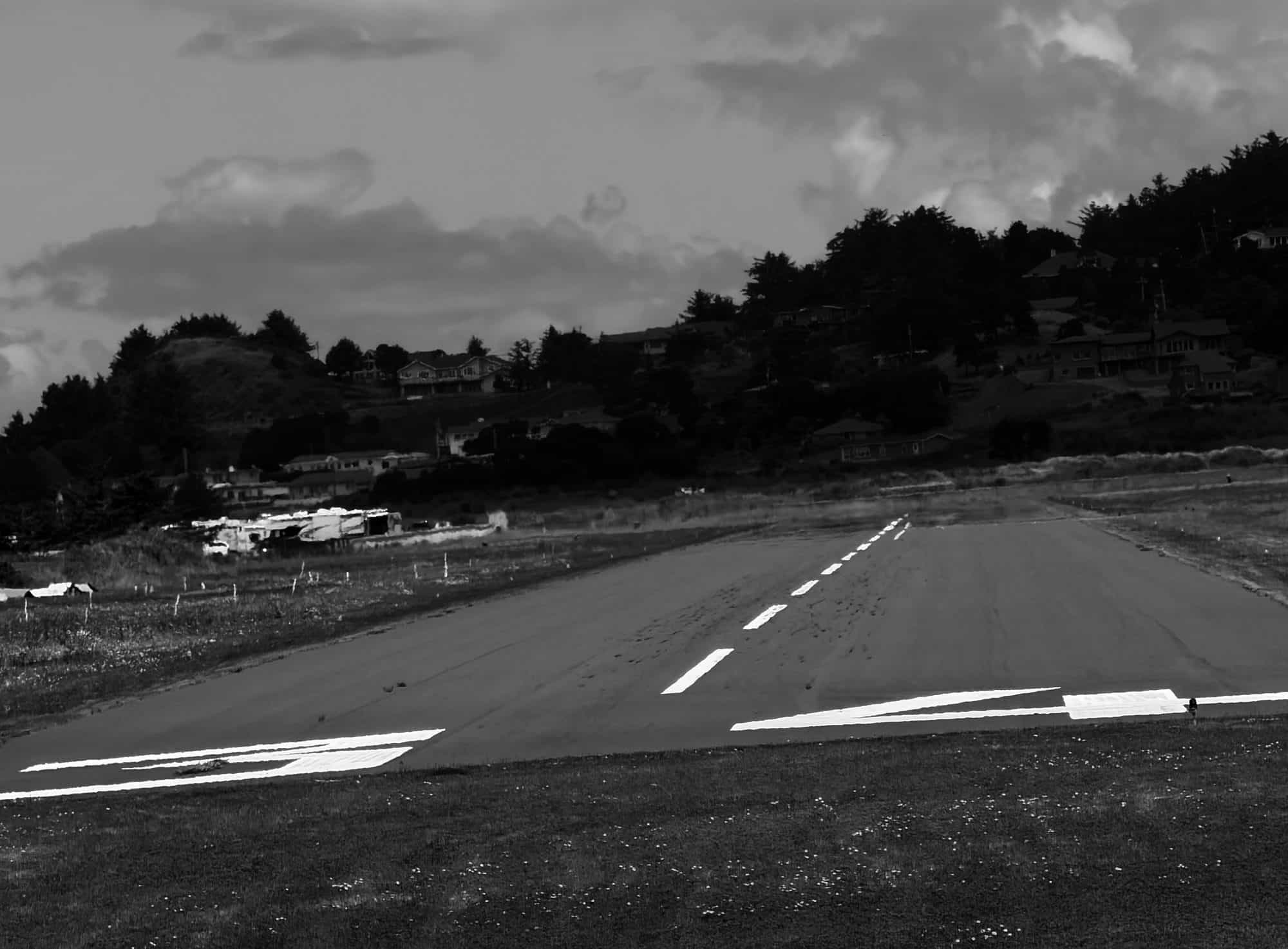 The runway at Gold Beach, Oregon, seen from the threshold with the coastal hills behind it.