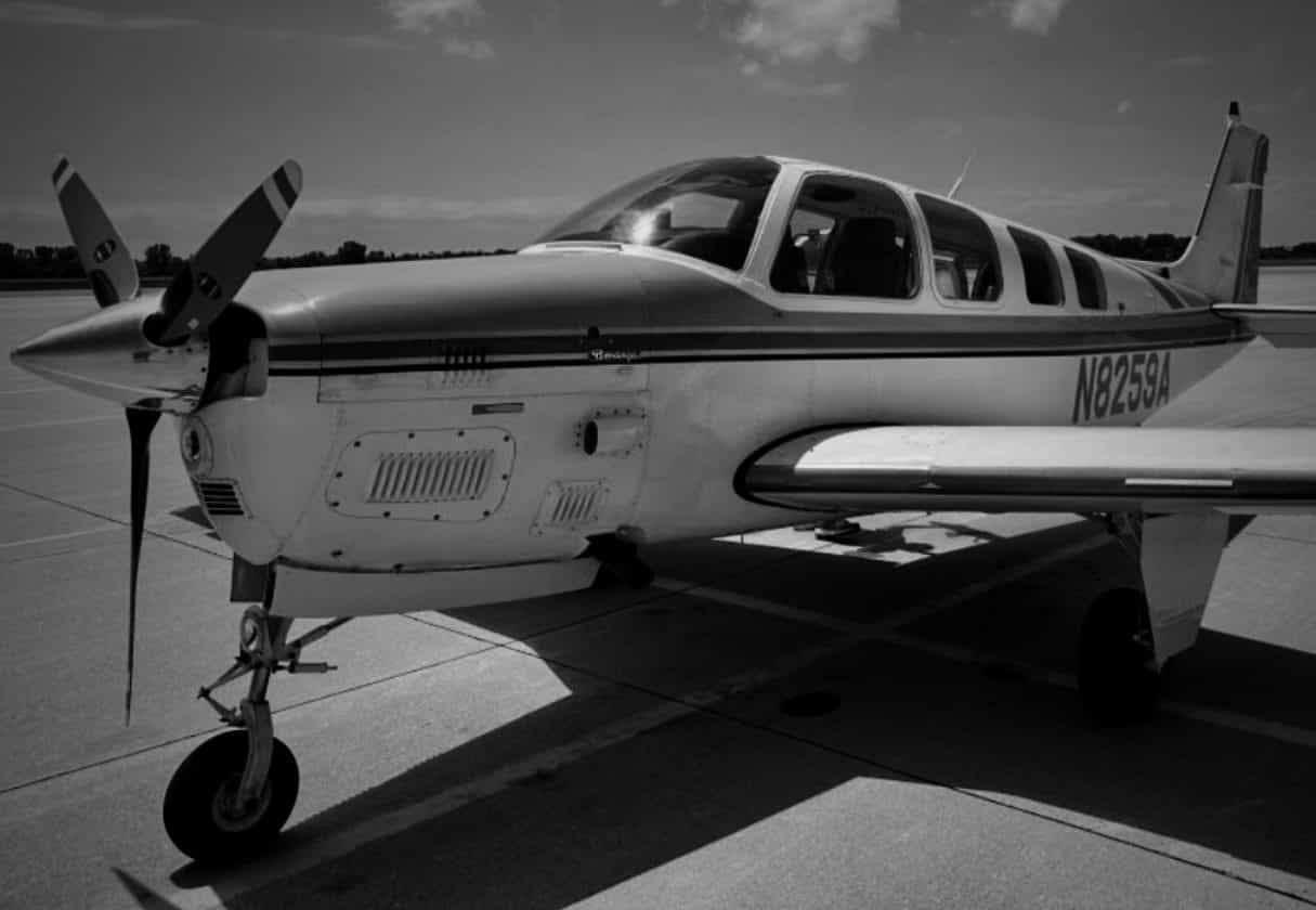 A Beechcraft Bonanza parked on the ramp in the morning sun.